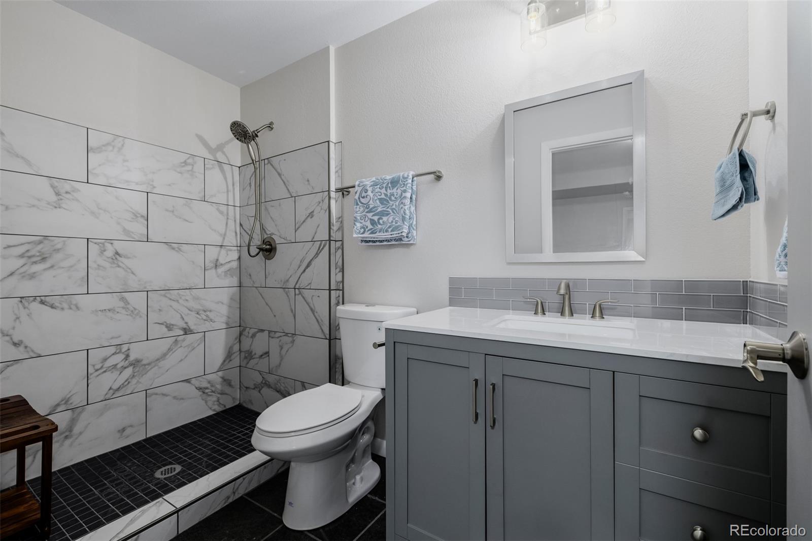 407 Double Tree Drive Greeley, CO 80634 - Photo 28 of 50 a bathroom with a sink toilet and shower