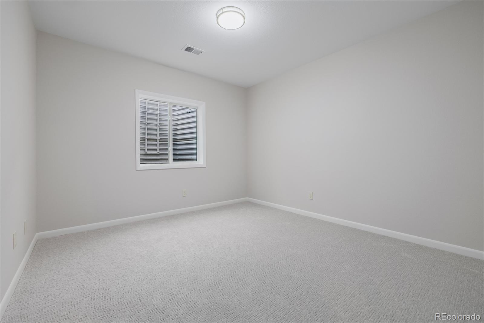 407 Double Tree Drive Greeley, CO 80634 - Photo 31 of 50 an empty room with a window