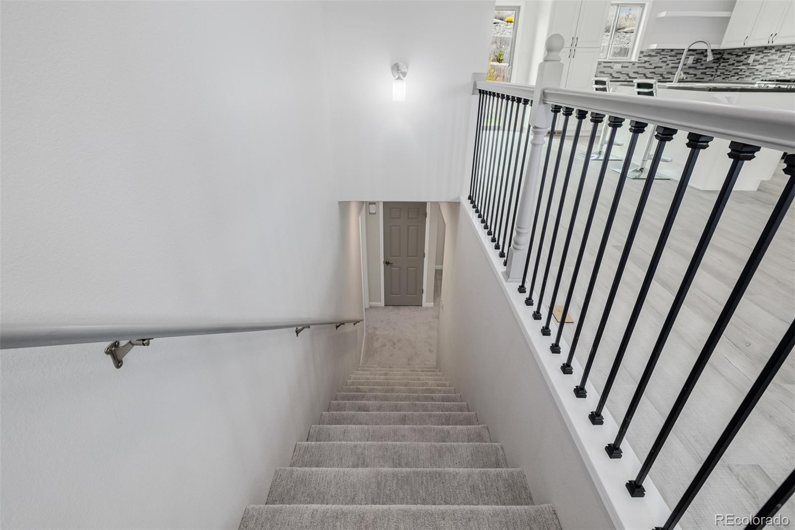 407 Double Tree Drive Greeley, CO 80634 - Photo 36 of 50 a view of staircase with white walls and railing