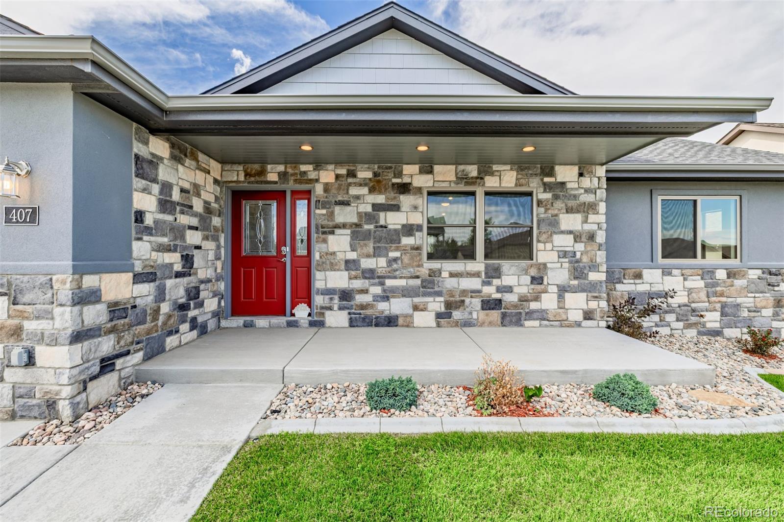 407 Double Tree Drive Greeley, CO 80634 - Photo 5 of 50 a front view of a house with garden
