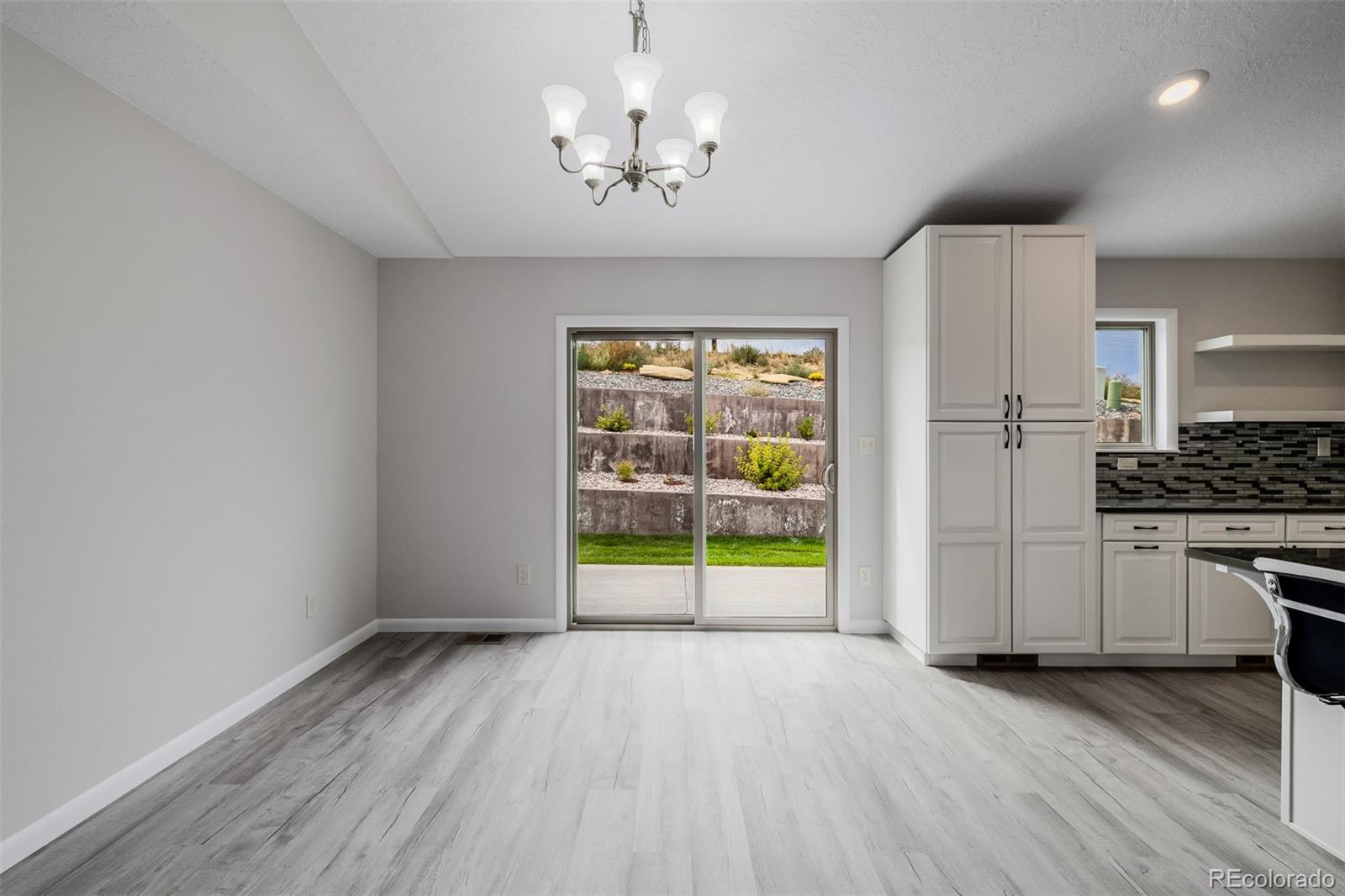 407 Double Tree Drive Greeley, CO 80634 - Photo 9 of 50 a view of an empty room with a window and wooden floor