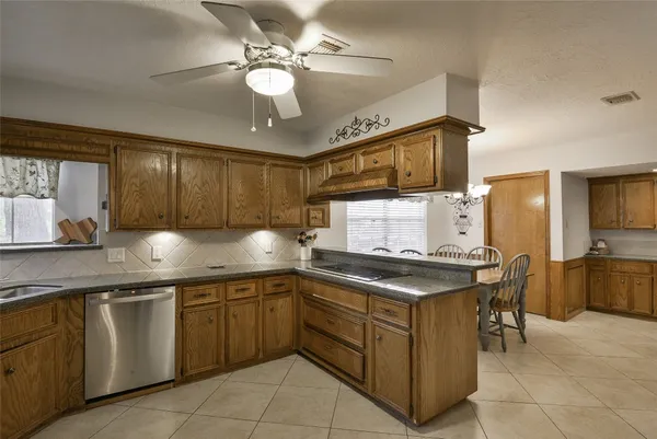 a kitchen with cabinets a sink and appliances