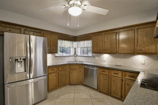 a kitchen with a refrigerator a sink and cabinets