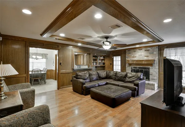 a living room with fireplace furniture and a flat screen tv
