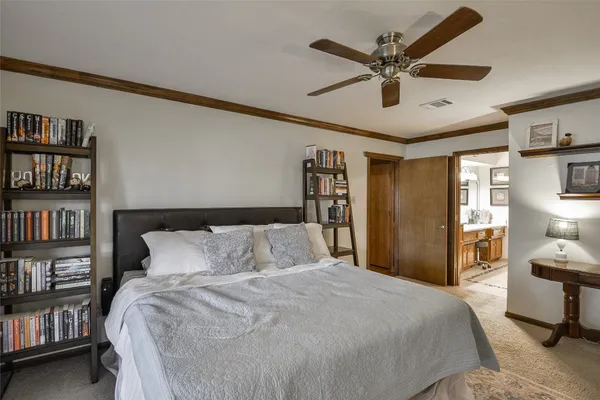 a bedroom with a bed and a book shelf