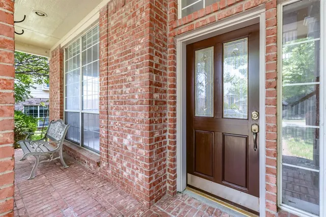a view of a porch with a table and chair
