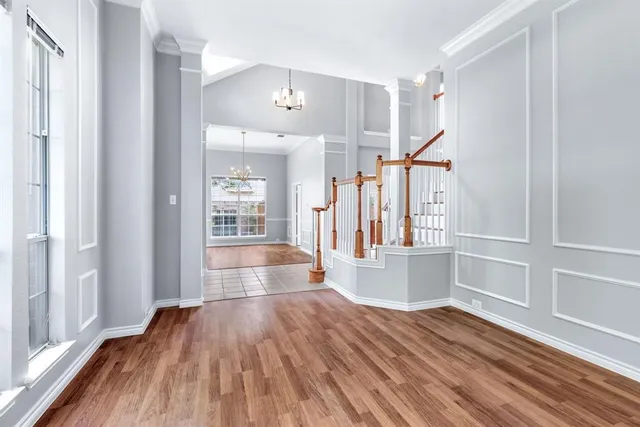 a view of hallway with wooden floor and stair