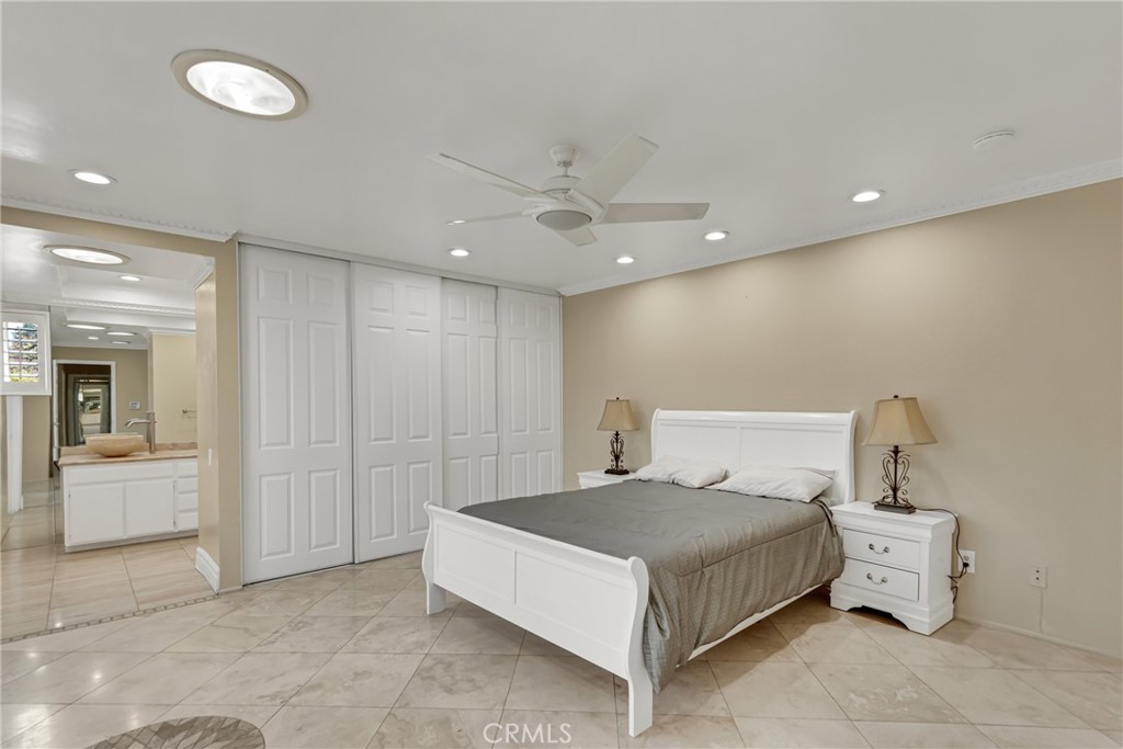 12 Oakdale Irvine, CA 92604 - Photo 34 of 53 a bedroom with a bed and a chandelier