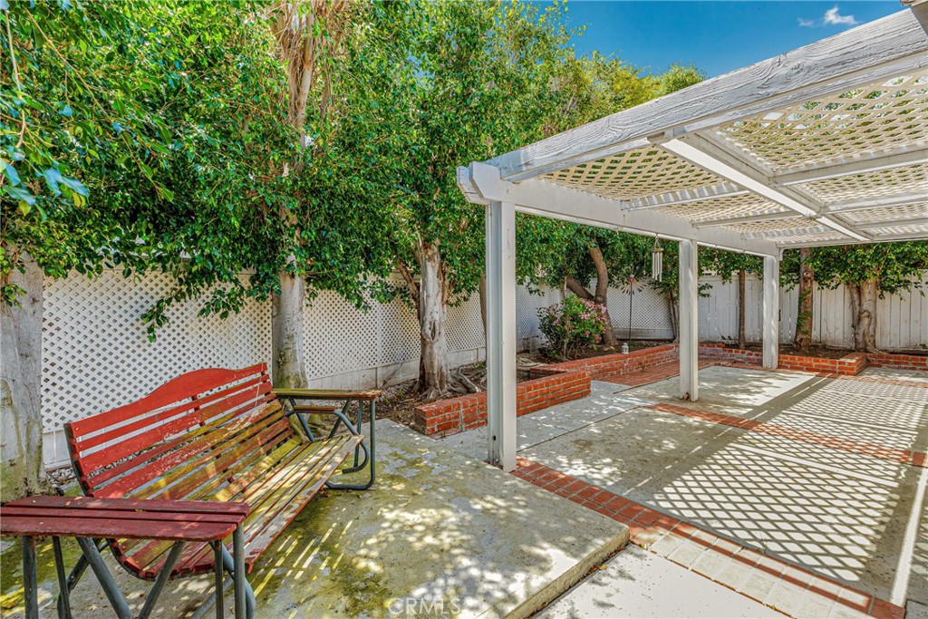 12 Oakdale Irvine, CA 92604 - Photo 45 of 53 a patio with a table and chairs and potted plants