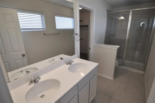 a view of a room with a ceiling fan and carpet