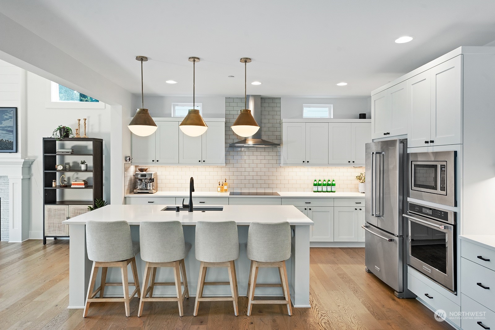 23932 104th Avenue West Edmonds, WA 98020 - Photo 10 of 39 a kitchen with a dining table chairs stainless steel appliances and wooden floor