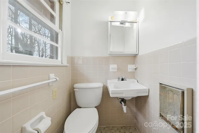 a bathroom with a sink mirror and toilet