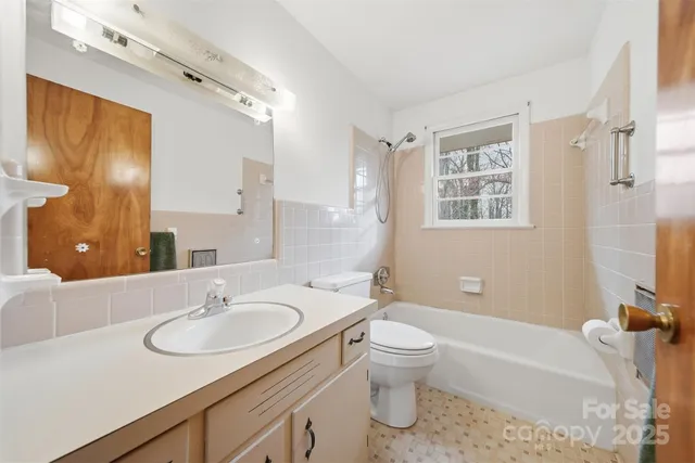 a bathroom with a sink toilet tub and shower
