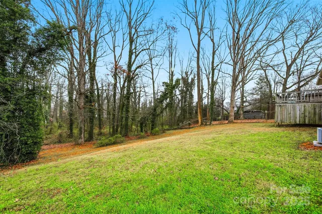 a view of swimming pool with trees and grass