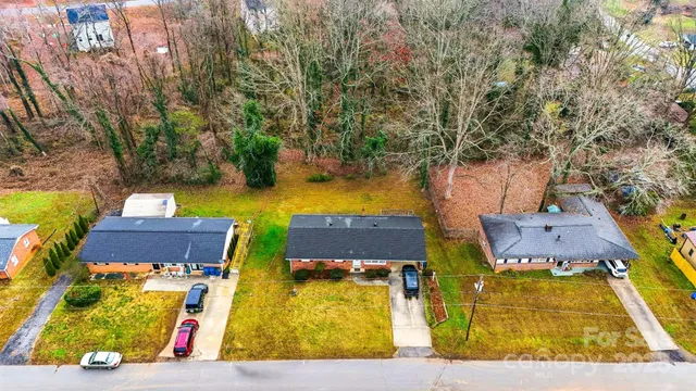 an aerial view of residential houses with yard