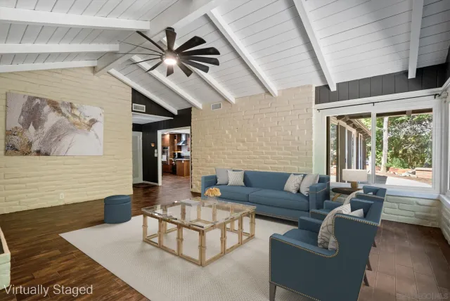 a view of a house with potted plants and large trees
