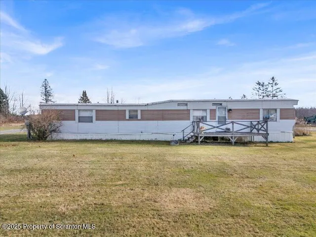 a swimming pool with outdoor seating and yard