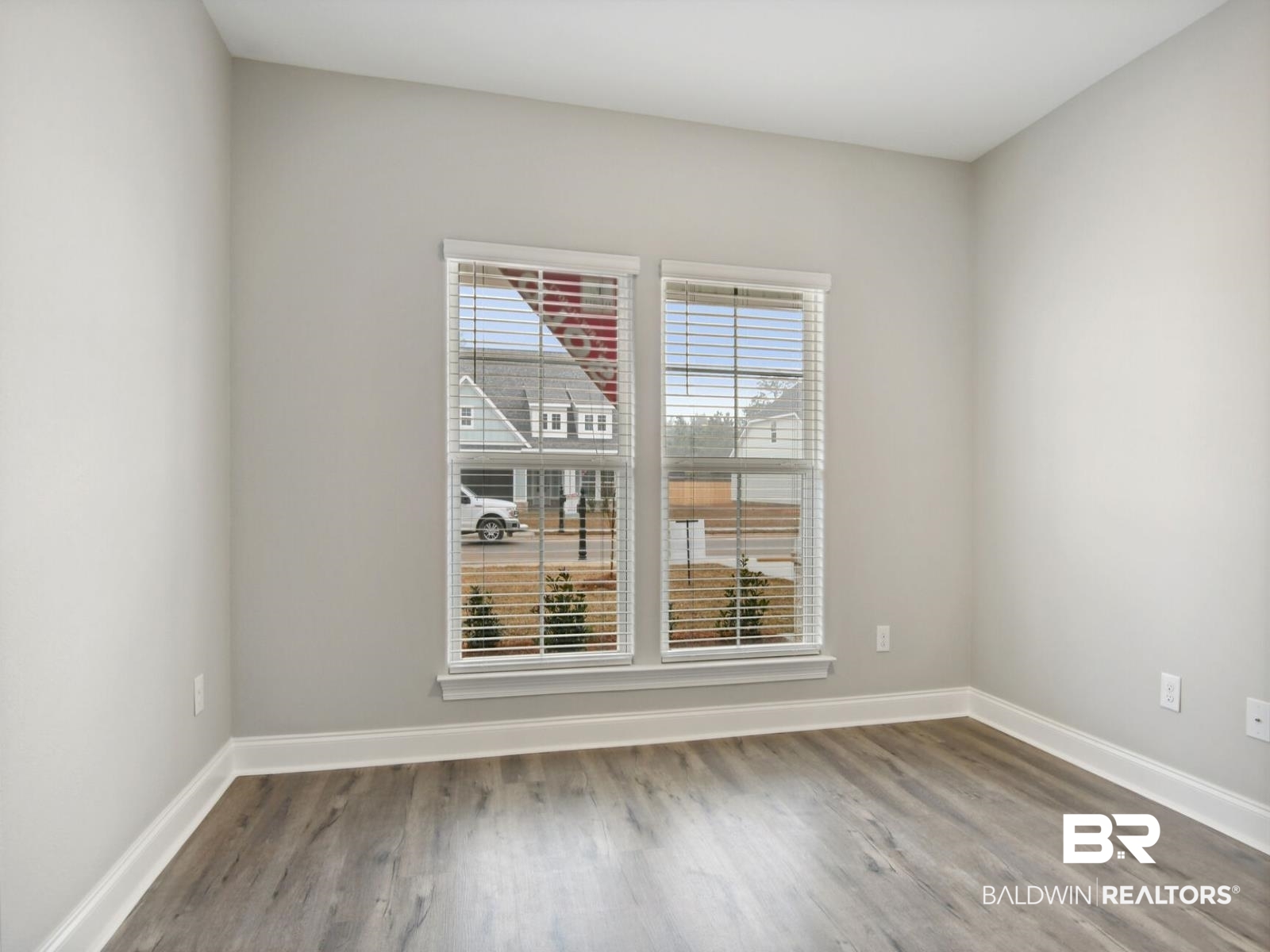 12922 Gondala Street Elberta, AL 36530 - Photo 4 of 20 Spare room featuring light wood-style floors and baseboards