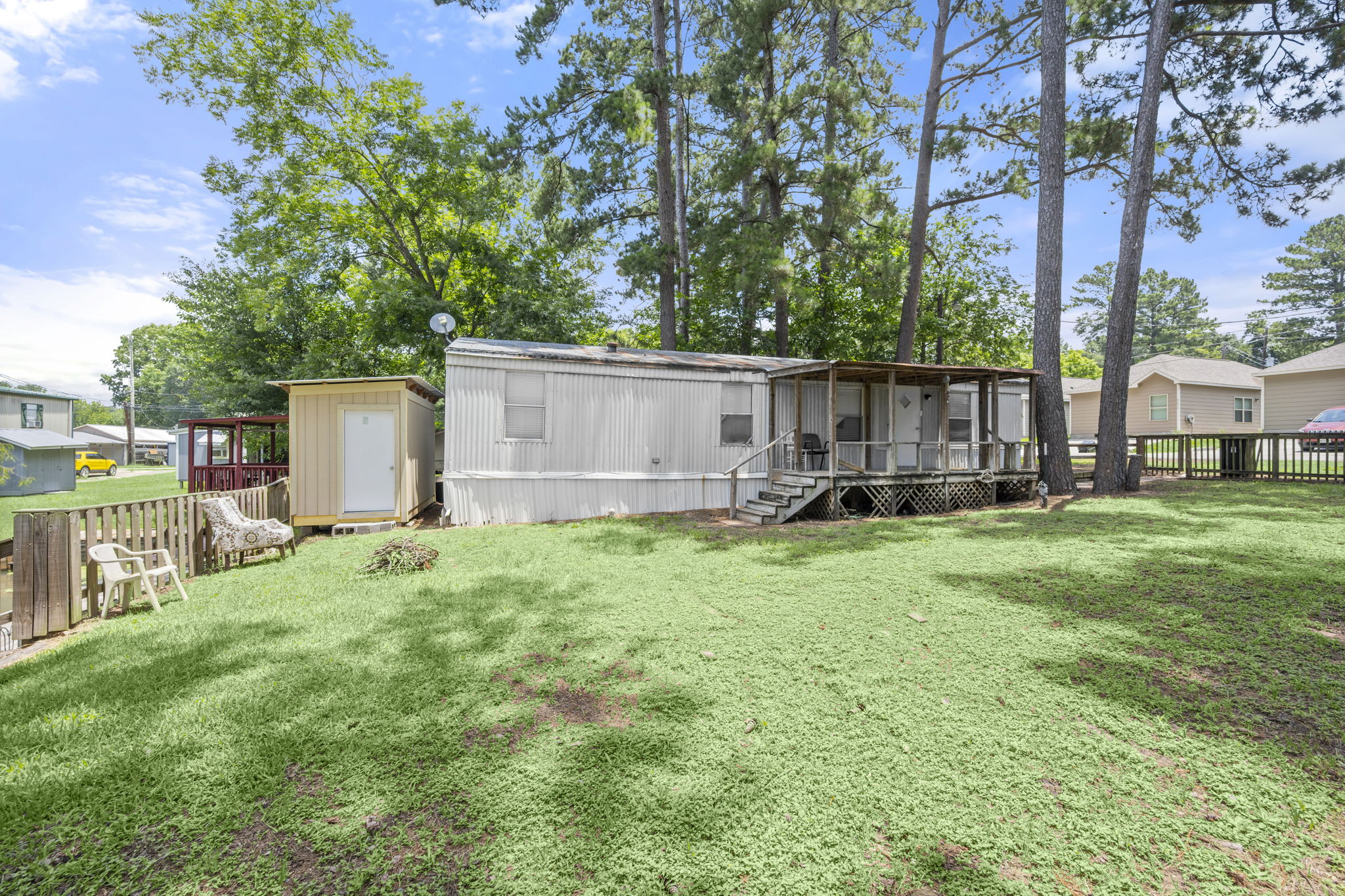 9649 Warm Spring Willis, TX 77318 - Photo 11 of 30 A welcoming front porch and spacious yard offer abundant outdoor living possibilities.