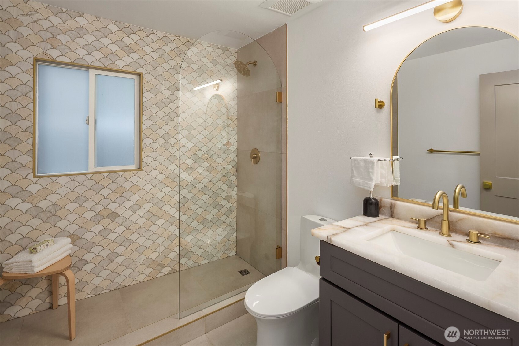 1016 Northwest 85th Street Seattle, WA 98117 - Photo 14 of 36 a bathroom with a sink a toilet and shower