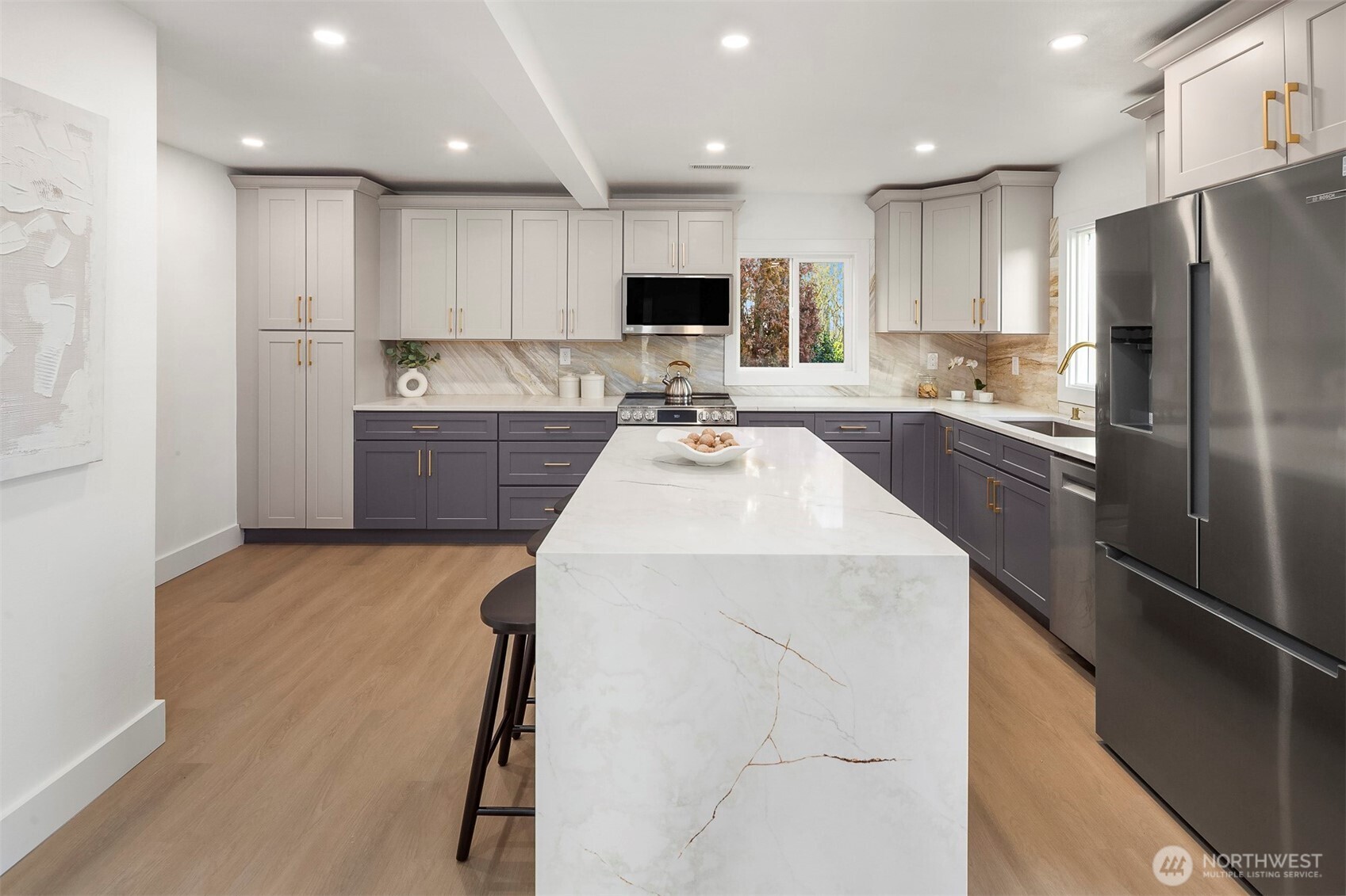 1016 Northwest 85th Street Seattle, WA 98117 - Photo 7 of 36 a kitchen with a refrigerator a sink and cabinets