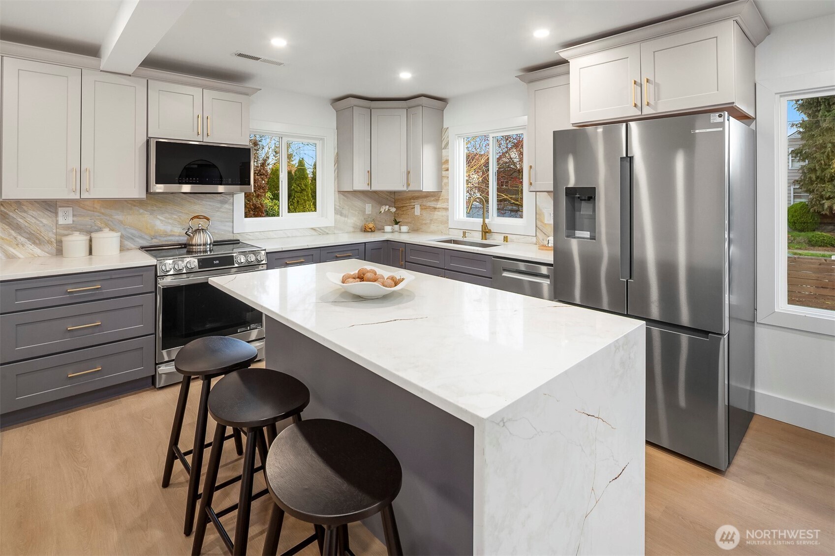 1016 Northwest 85th Street Seattle, WA 98117 - Photo 10 of 36 a kitchen with a refrigerator a stove a sink and chairs