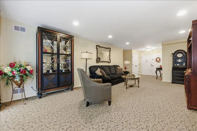 a living room with furniture and flowers
