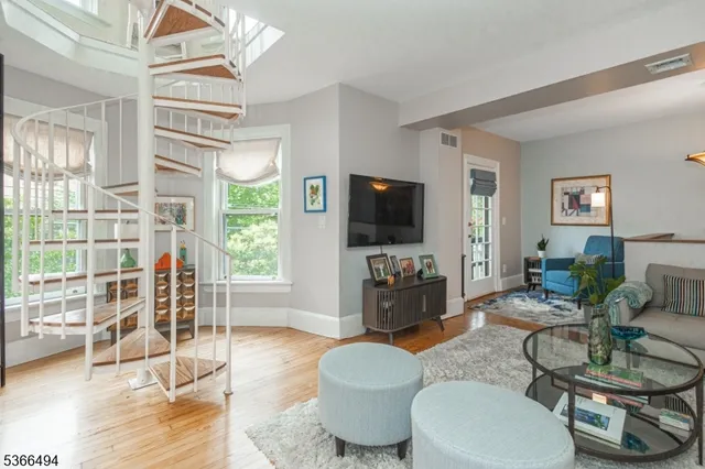 a living room with furniture fireplace and wooden floor