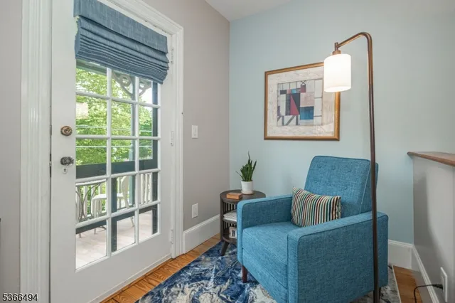 a living room with furniture and a floor to ceiling window