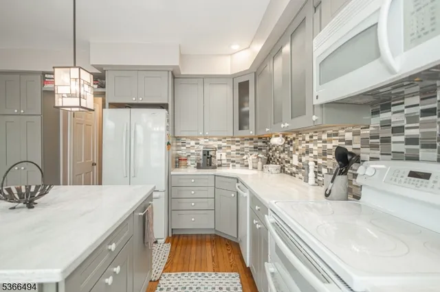 a dining room with furniture a chandelier and wooden floor