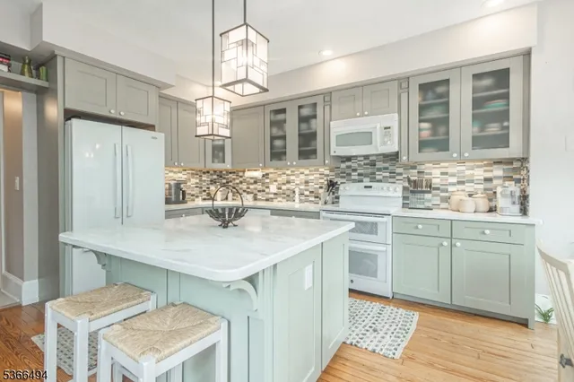 a kitchen with sink refrigerator and large window