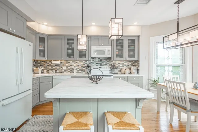 a view of a livingroom with wooden floor and a large window