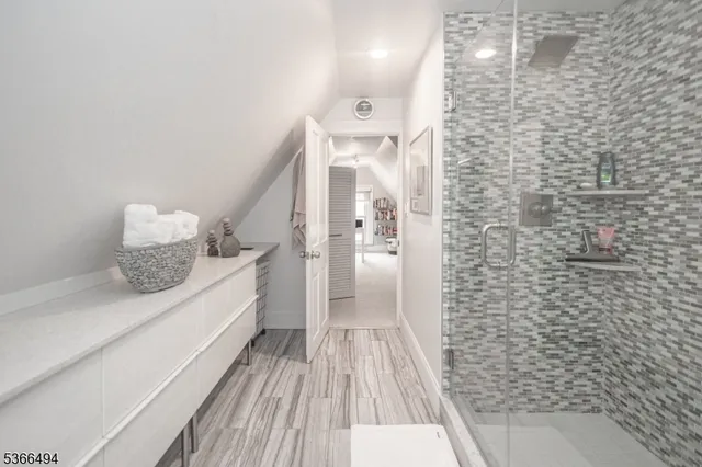 an aerial view of a house with garden space and trees