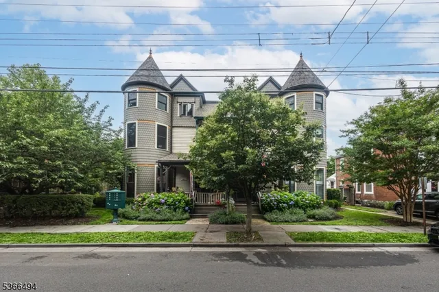 a front view of a house with a garden and plants