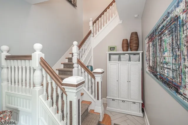 a view of entryway with wooden floor and stairs