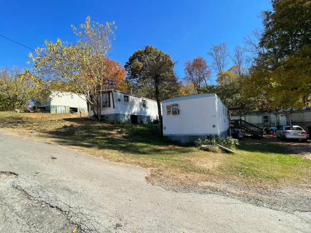 a view of a house with truck parked in front of a house