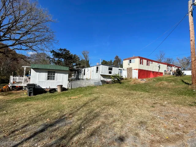 a swimming pool with outdoor seating and yard