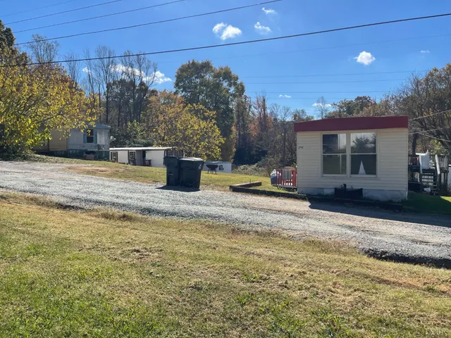 a view of a backyard with table and chairs under an umbrella