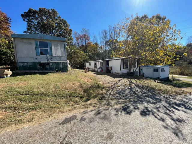 a view of a house with yard and sitting area