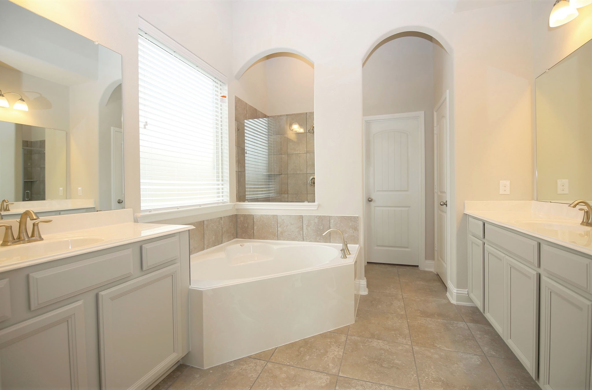 8218 Oxbow Manor Lane Cypress, TX 77433 - Photo 14 of 37 a bathroom with a tub a sink and a mirror