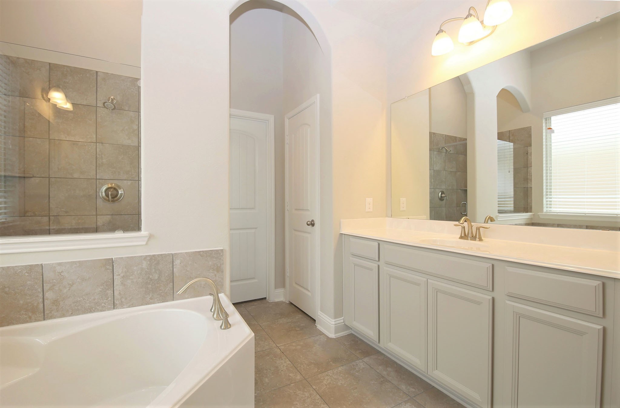 8218 Oxbow Manor Lane Cypress, TX 77433 - Photo 16 of 37 a bathroom with a tub sink and mirror