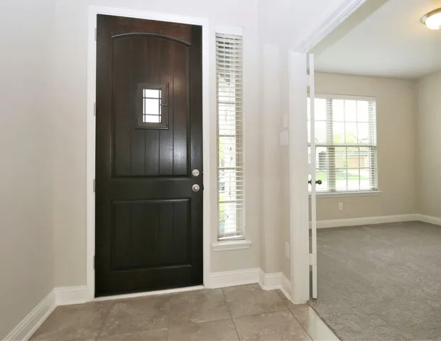 an empty room with closet and windows