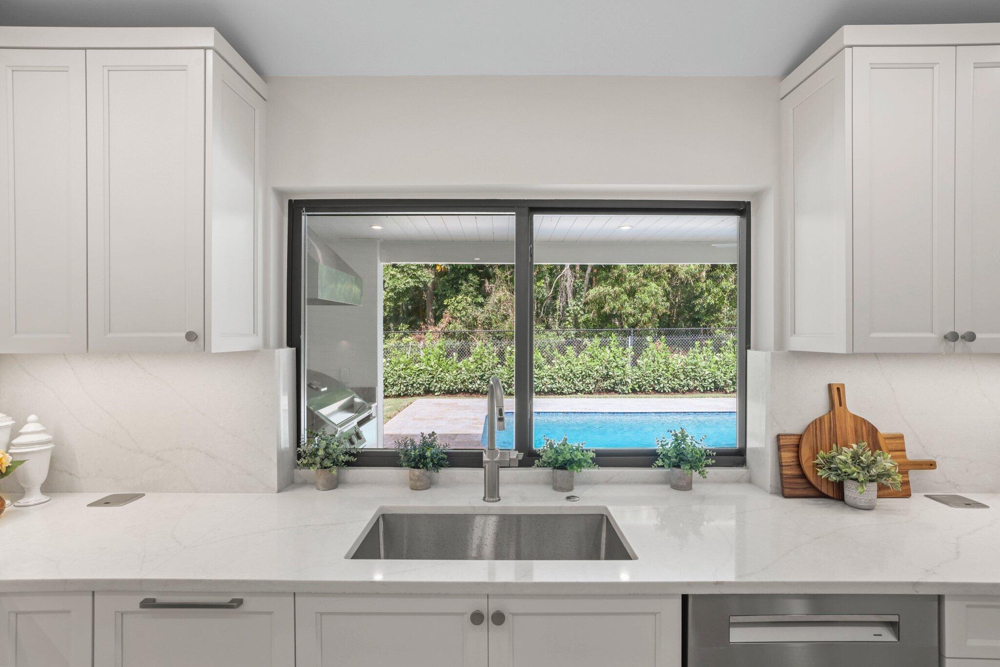 3901 Northwest 27th Avenue Boca Raton, FL 33434 - Photo 25 of 56 a kitchen with a sink and large window