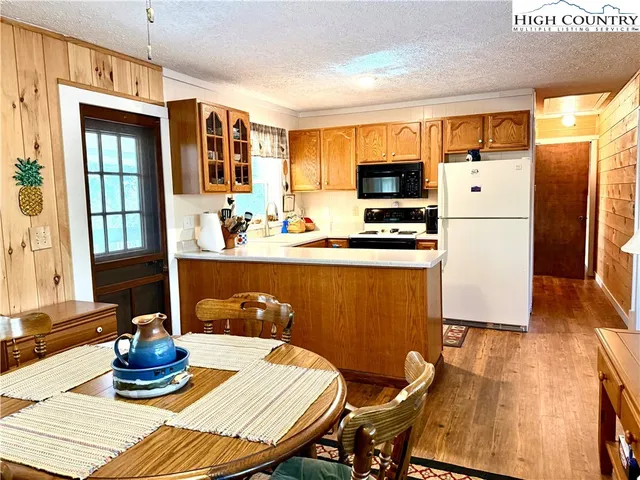 a kitchen with a refrigerator and a stove top oven