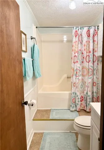 a bathroom with a bathtub and a window