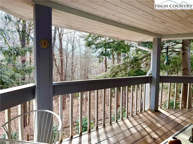 a view of a porch with wooden floor and outdoor seating