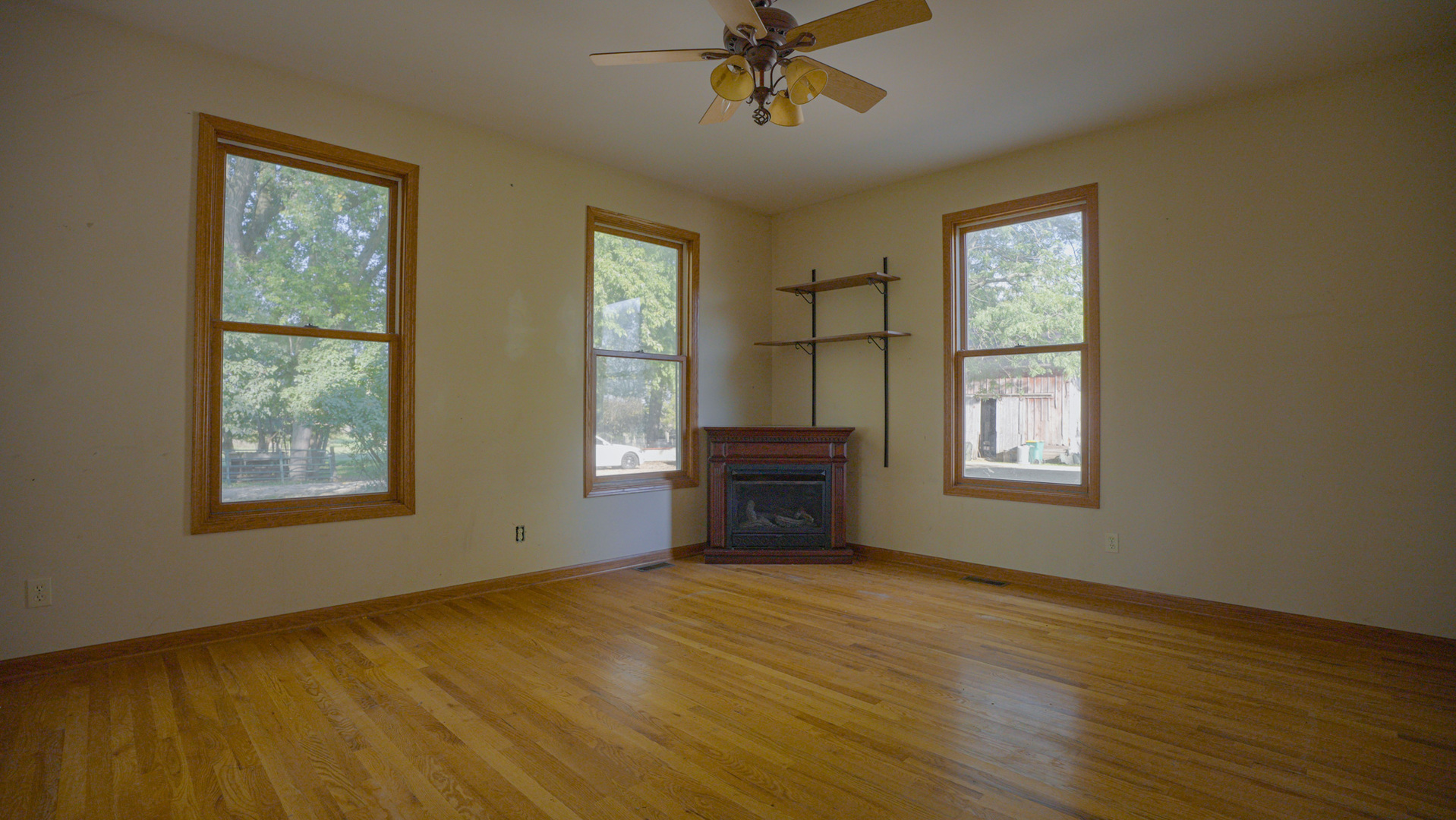 9282 East Hemstock Road Rochelle, IL 61068 - Photo 11 of 68 a view of an empty room with a window and wooden floor