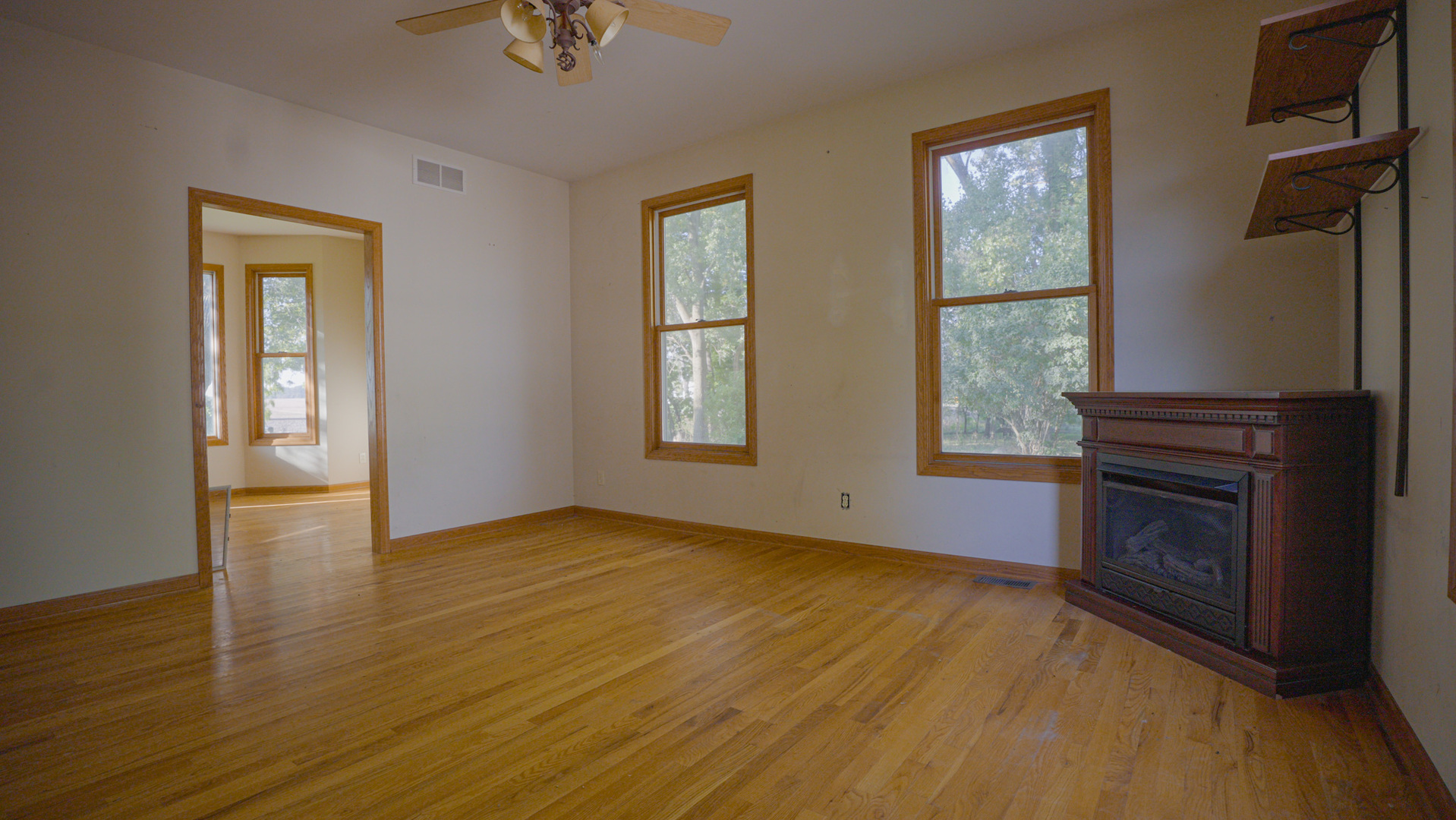 9282 East Hemstock Road Rochelle, IL 61068 - Photo 12 of 68 a view of an empty room with window and wooden floor