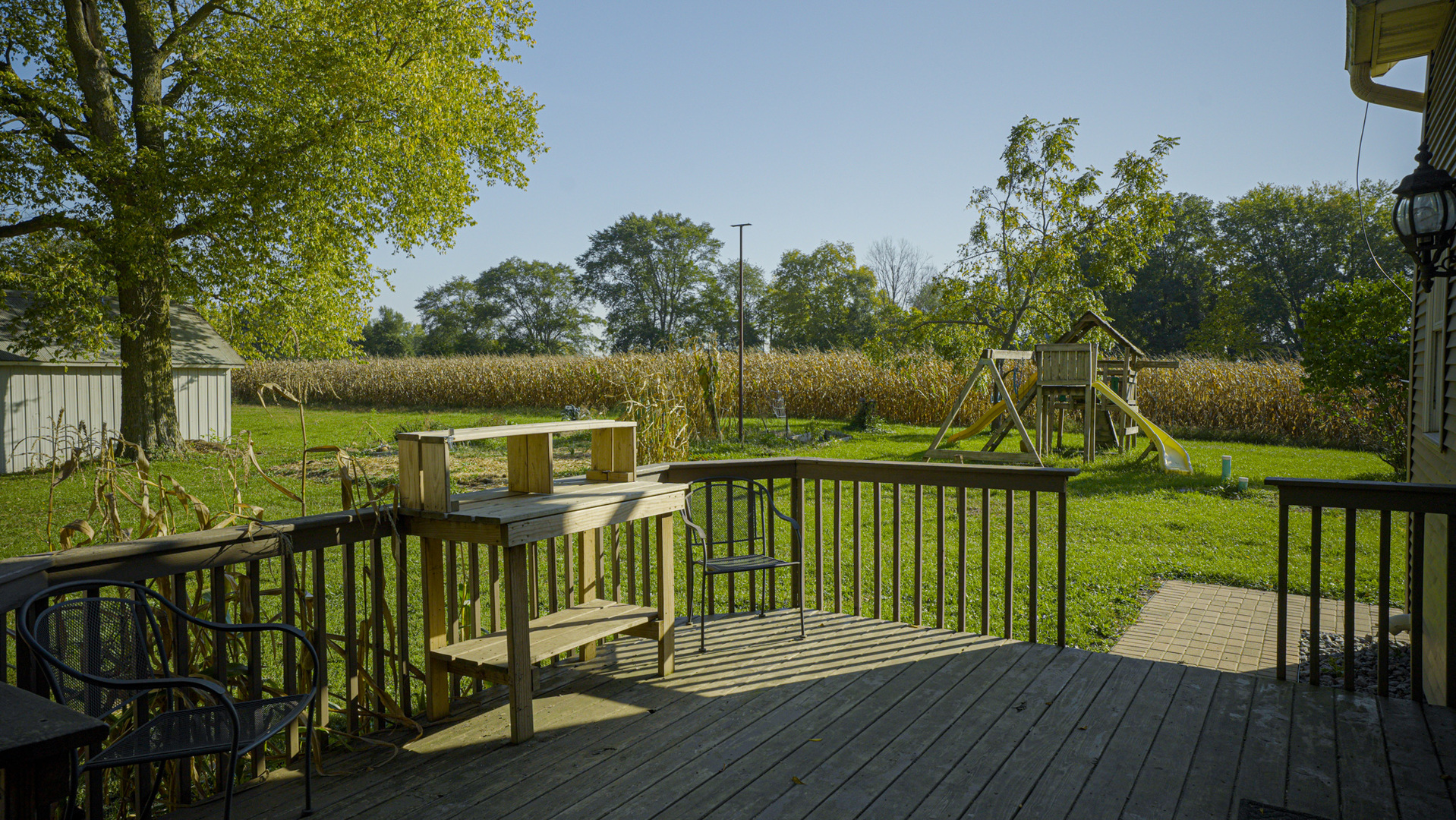 9282 East Hemstock Road Rochelle, IL 61068 - Photo 30 of 68 a view of a deck with two chair and wooden floor