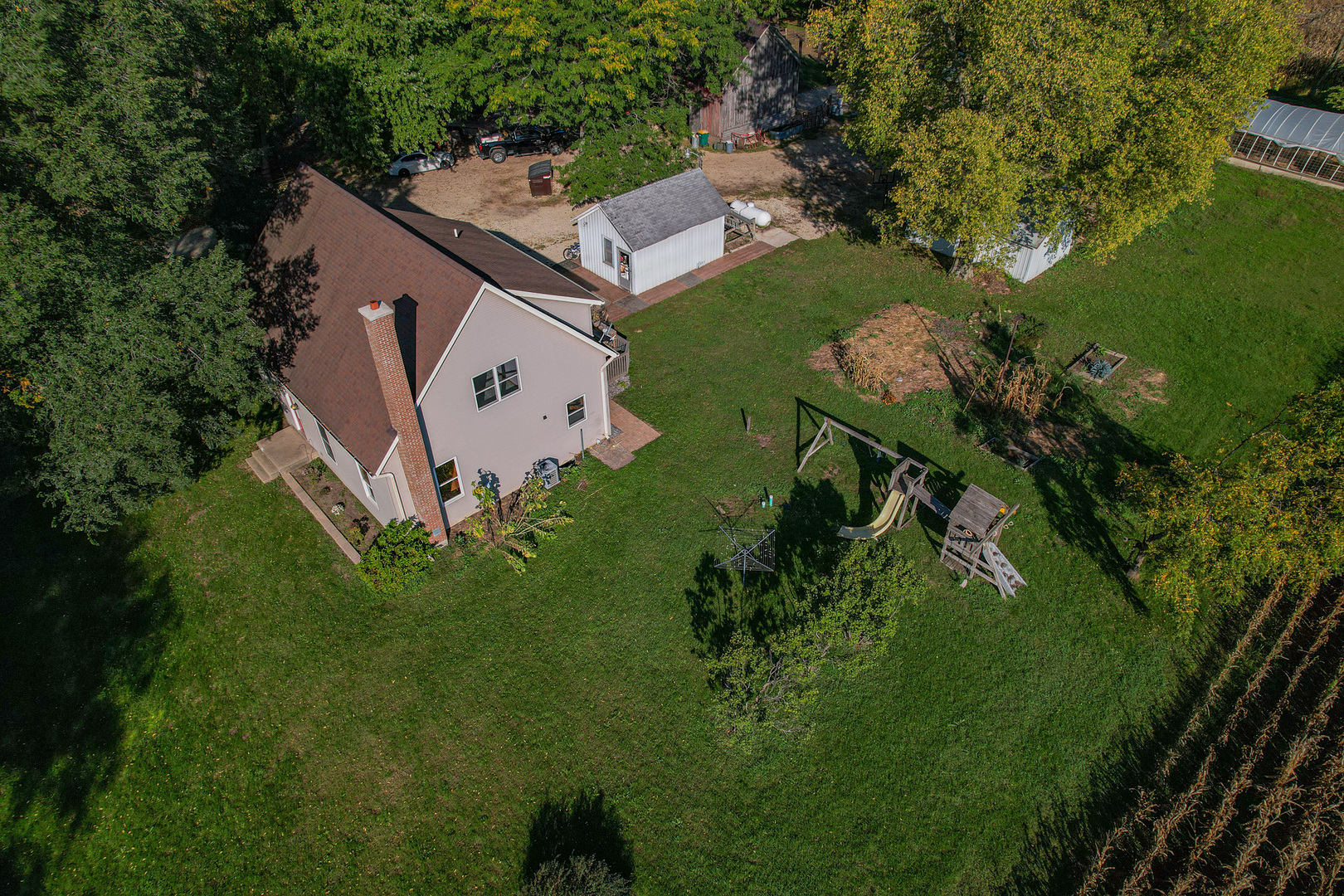 9282 East Hemstock Road Rochelle, IL 61068 - Photo 5 of 68 an aerial view of a house with a garden and lake view